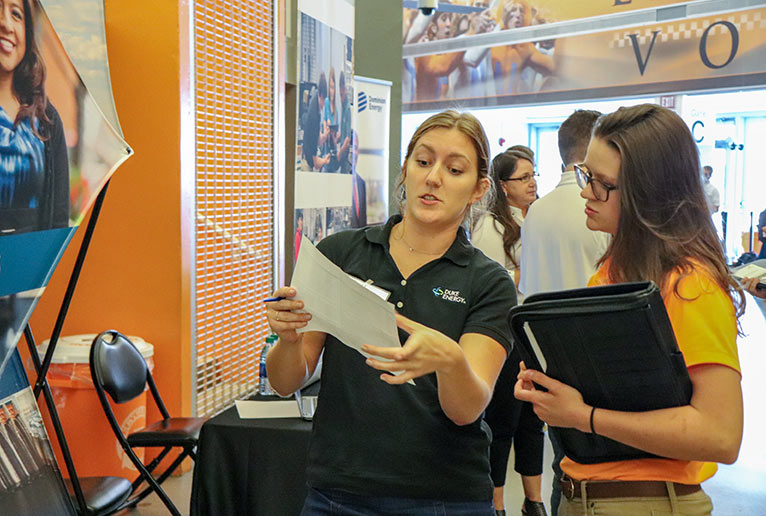 Student Talks with Duke Energy Representative at the Engineering Expo
